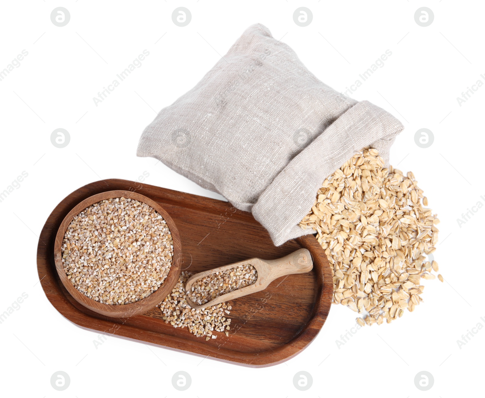 Photo of Dry wheat groats in bowl, scoop and sack with oat flakes isolated on white, top view