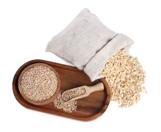 Photo of Dry wheat groats in bowl, scoop and sack with oat flakes isolated on white, top view