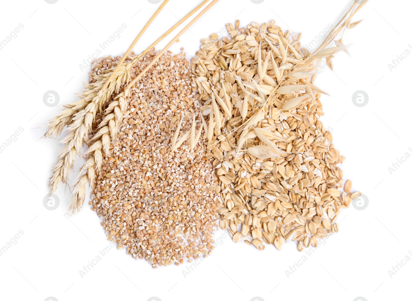 Photo of Raw wheat groats, oat flakes and spikelets isolated on white, top view