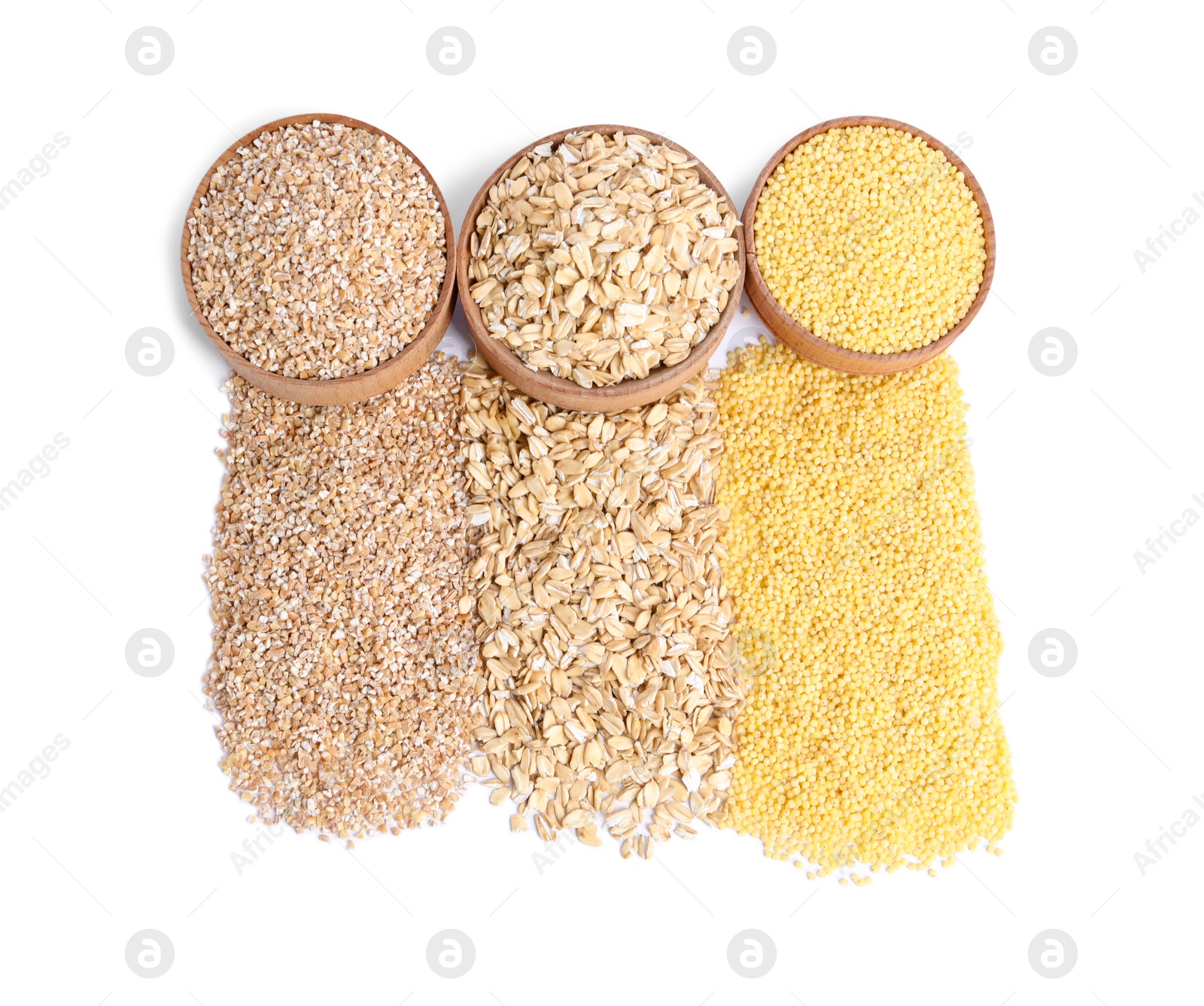 Photo of Piles of different cereals and bowls isolated on white, top view