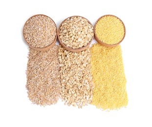 Photo of Piles of different cereals and bowls isolated on white, top view