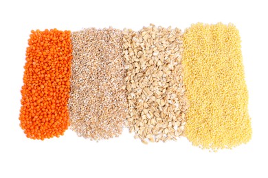 Piles of different cereals and lentils isolated on white, top view