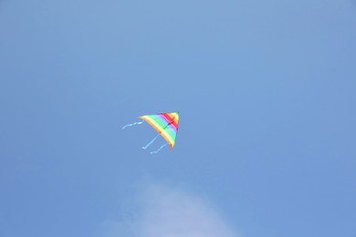 One colorful kite flying in blue sky