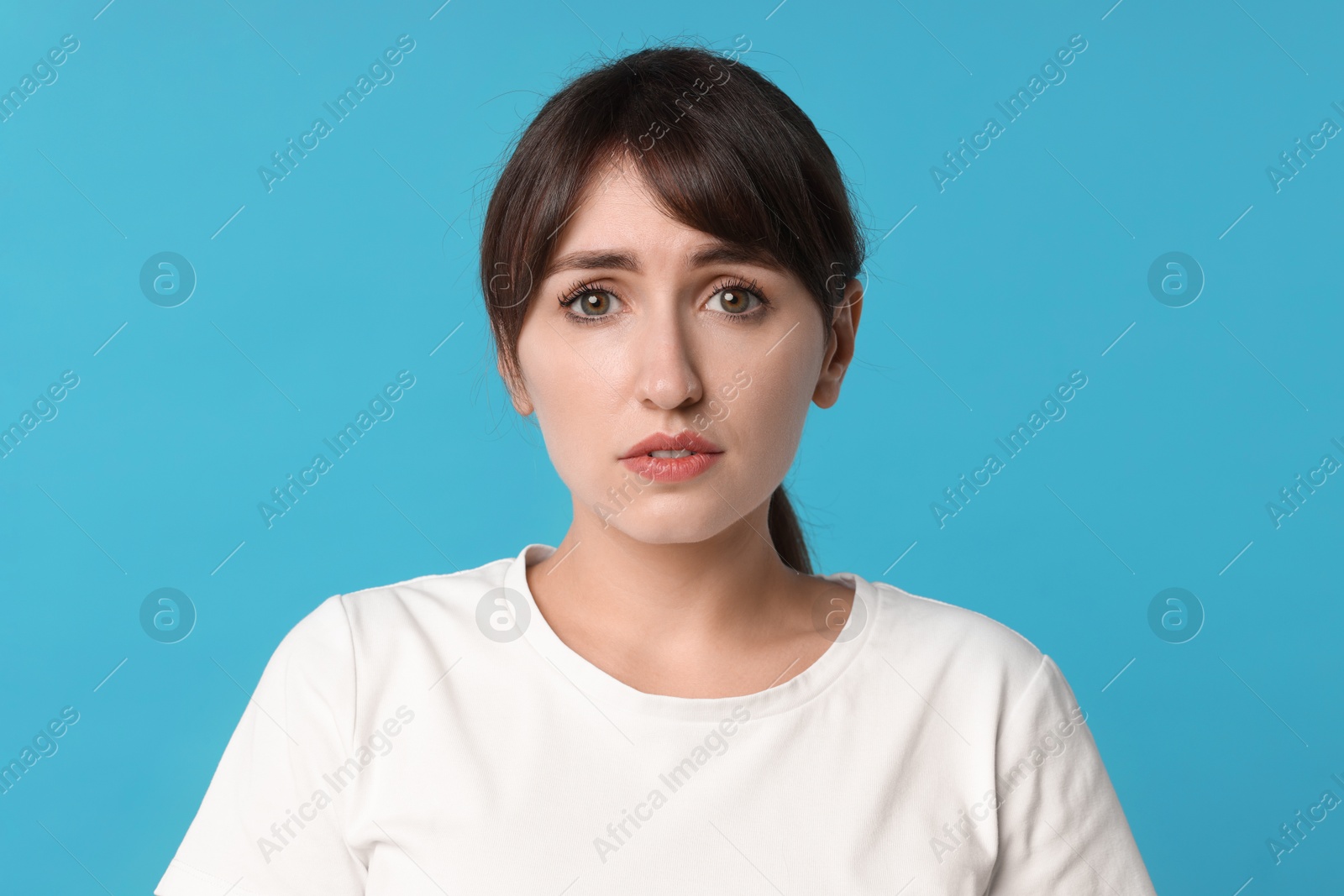 Photo of Portrait of frustrated woman on light blue background