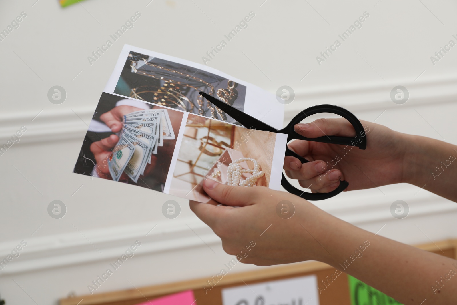 Photo of Creating vision board. Woman cutting out picture at home, closeup