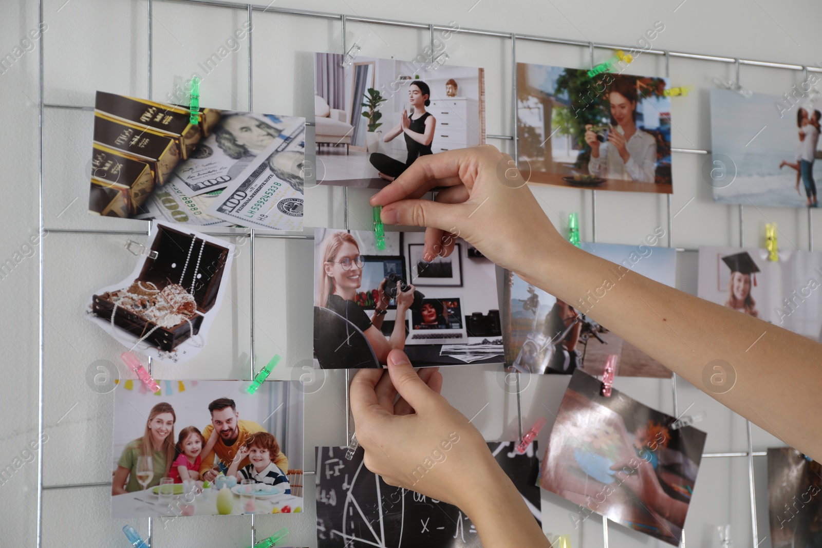 Photo of Woman creating vision board with different photos indoors, closeup