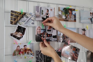 Woman creating vision board with different photos indoors, closeup