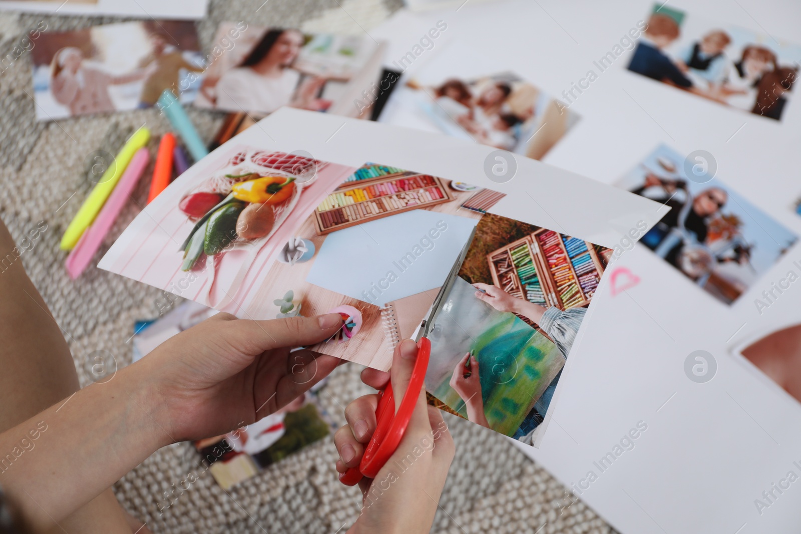 Photo of Creating vision board. Woman cutting out picture on floor indoors, closeup