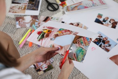 Photo of Creating vision board. Woman cutting out picture on floor indoors, closeup