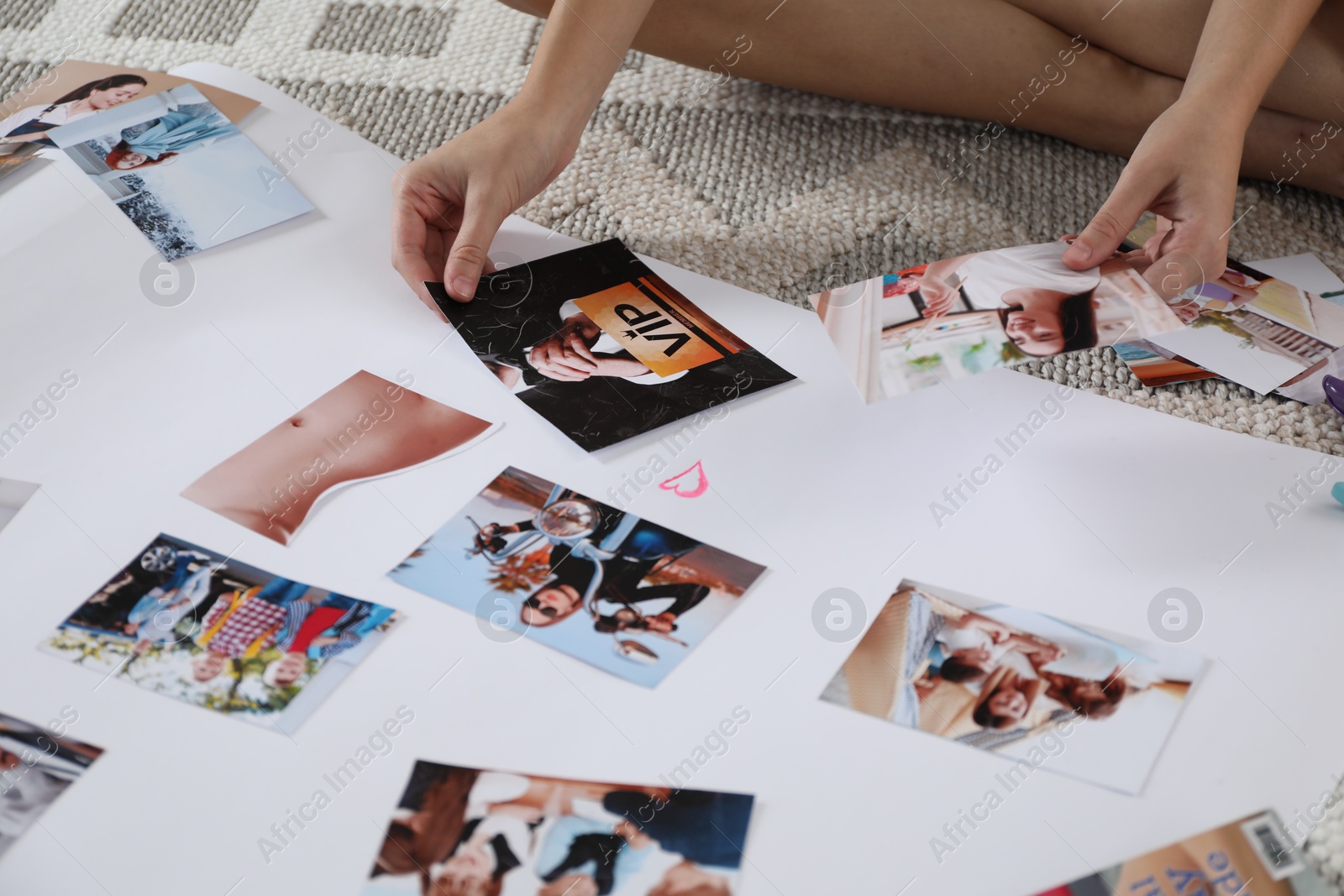 Photo of Woman creating vision board with different photos on floor indoors, closeup