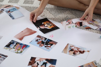 Photo of Woman creating vision board with different photos on floor indoors, closeup