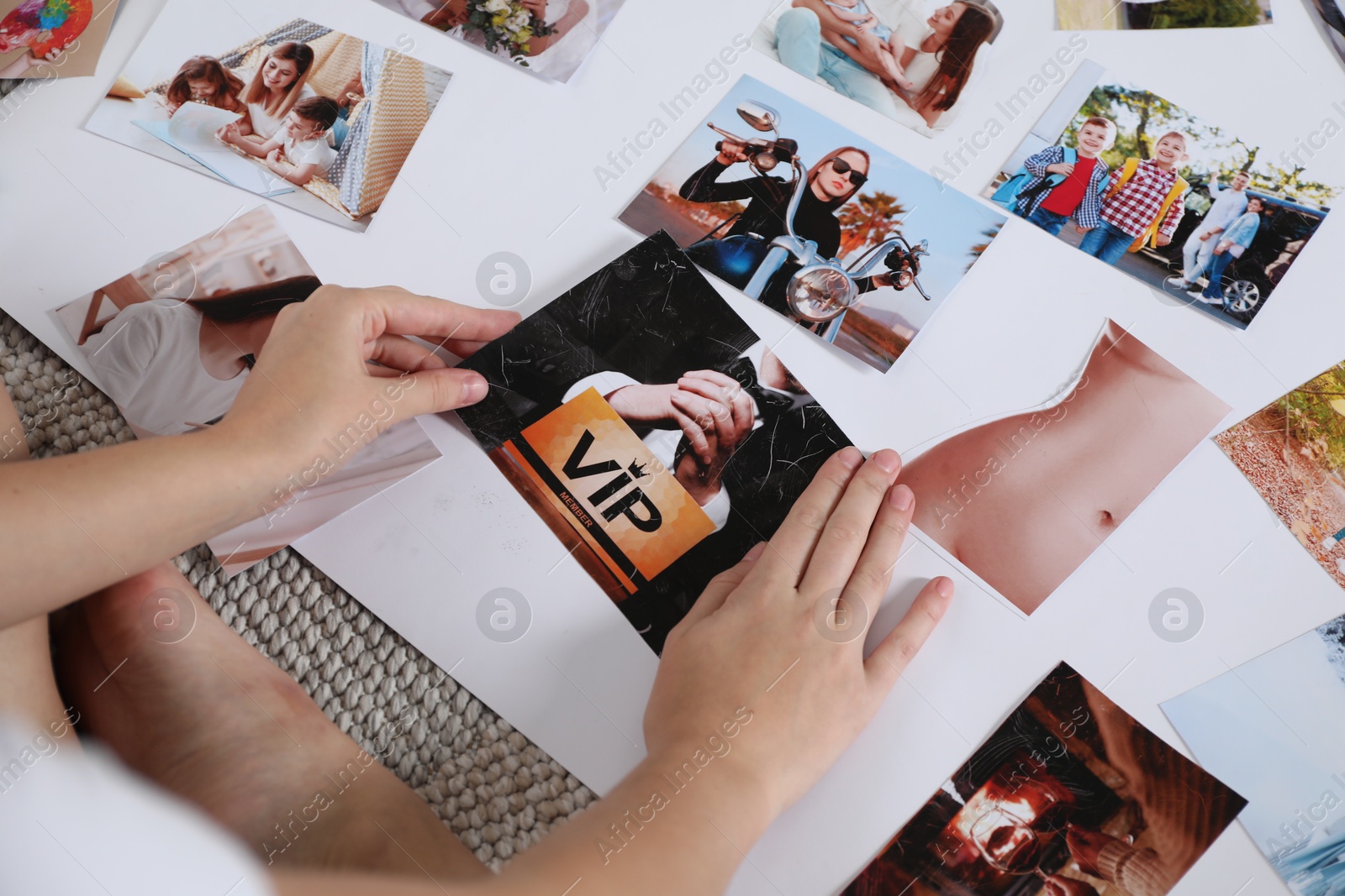 Photo of Woman creating vision board with different photos on floor indoors, closeup