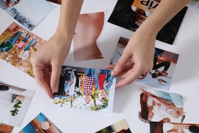 Woman creating vision board with different photos, closeup