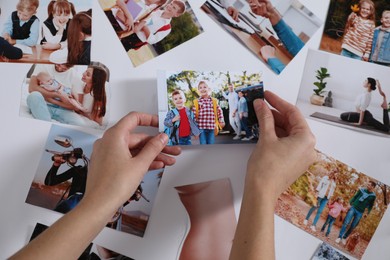 Woman creating vision board with different photos, top view