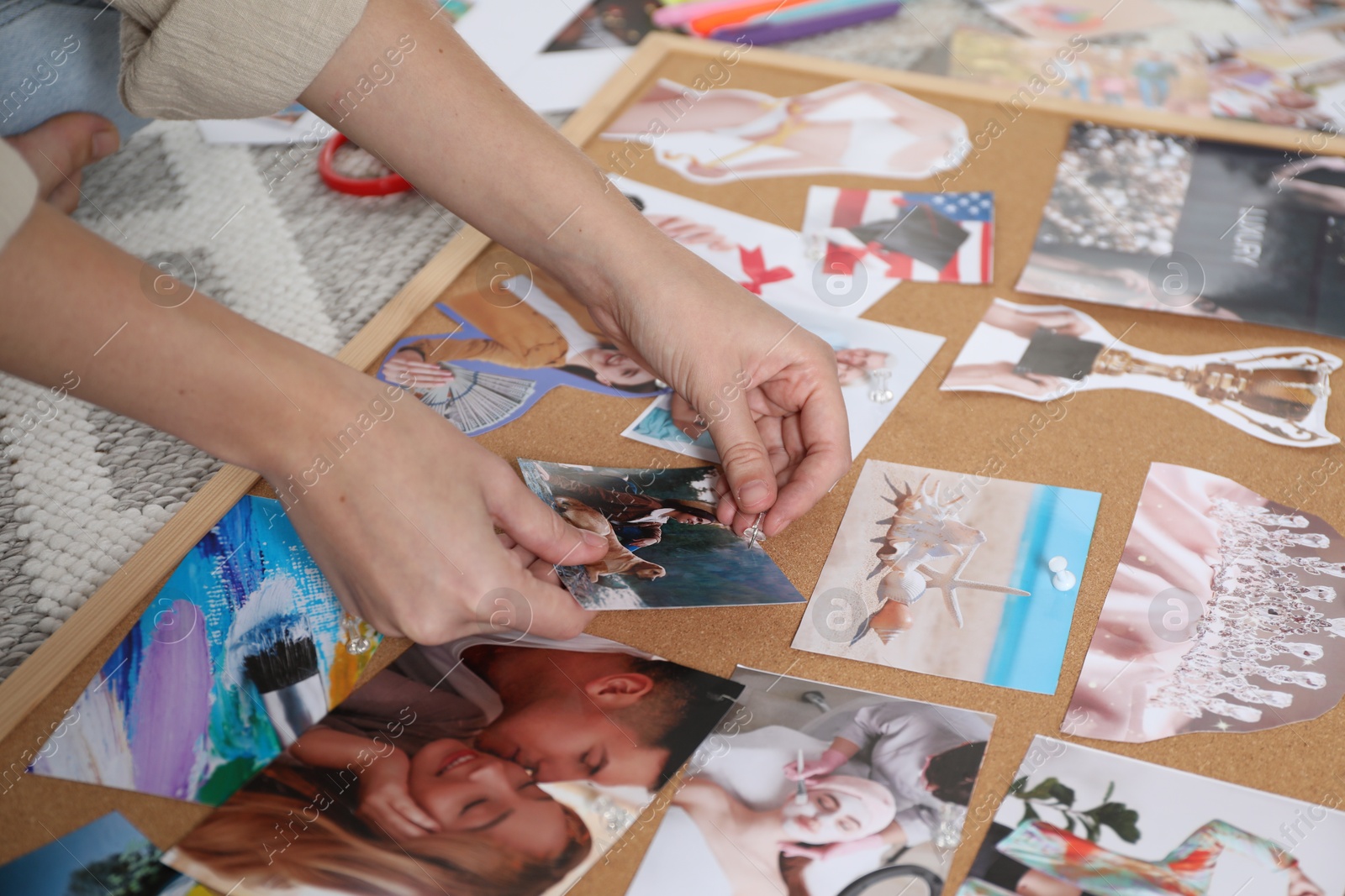 Photo of Woman creating vision board with different photos and other elements on floor indoors, closeup