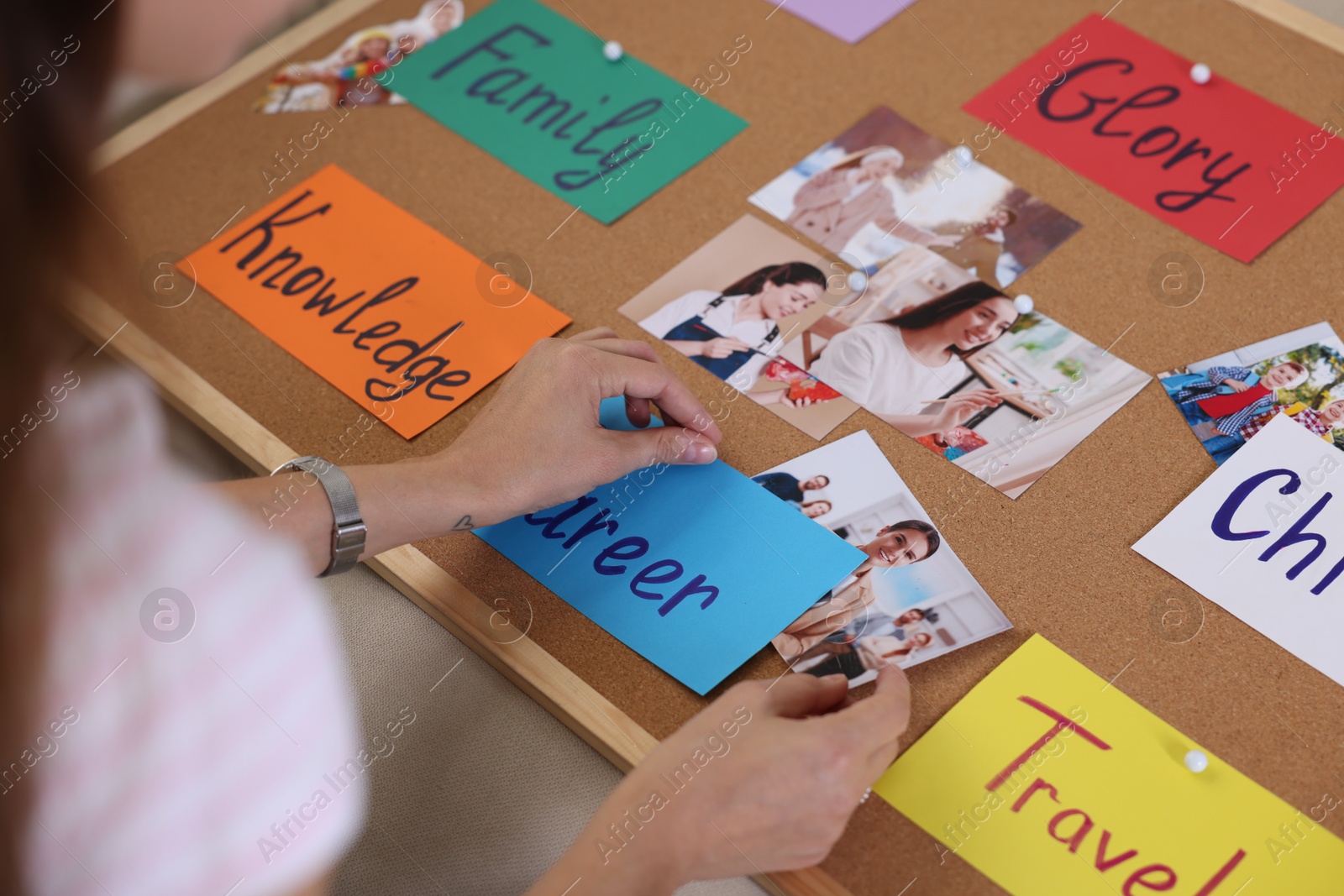 Photo of Woman creating vision with different photos and other elements board indoors, closeup