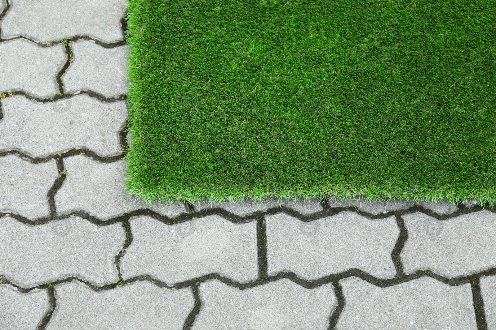 Photo of Sheet of green artificial turf in yard, above view