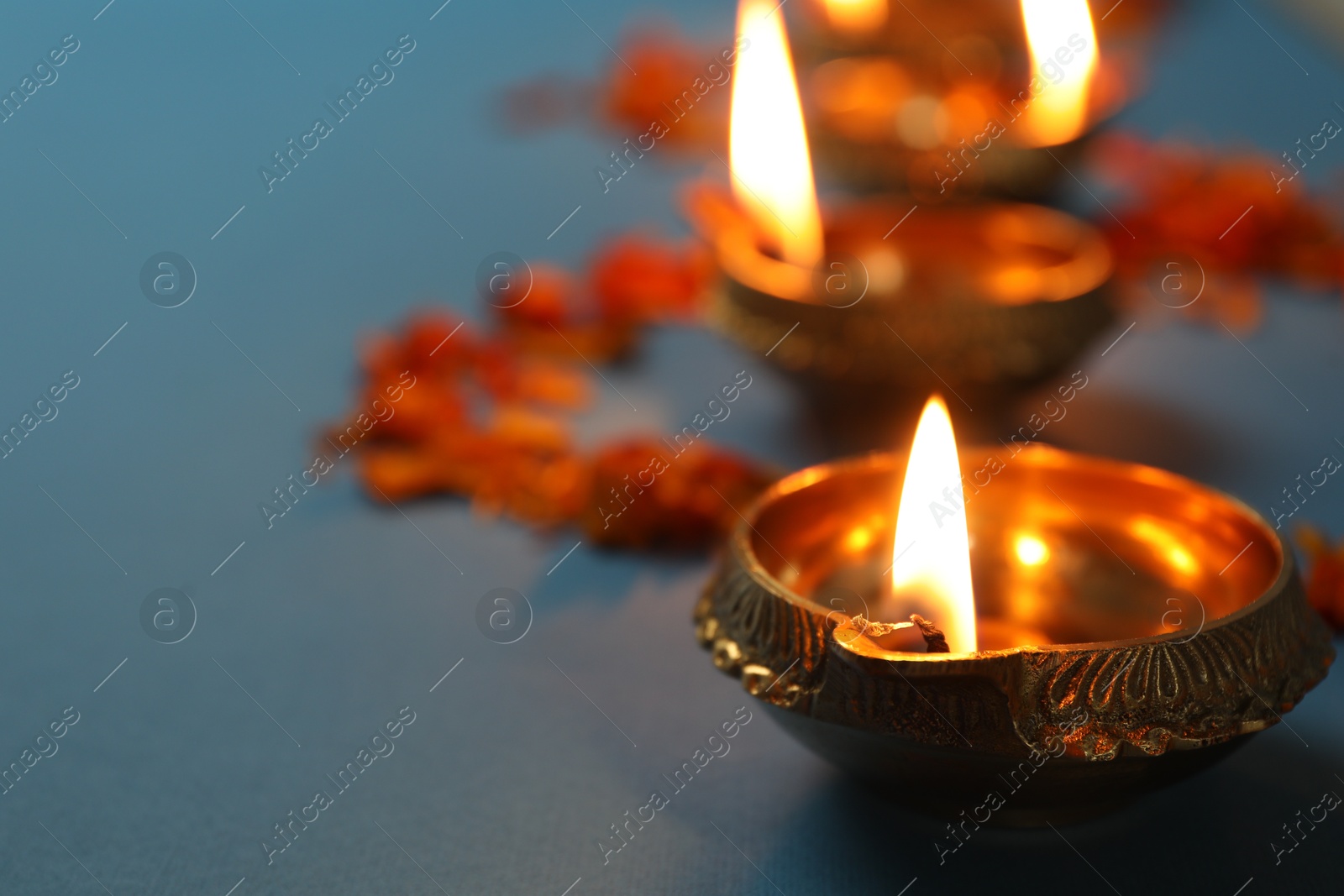 Photo of Diwali celebration. Diya lamps gray background, closeup. Space for text