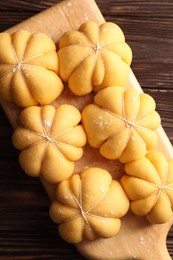 Photo of Raw pumpkin shaped buns on wooden table, top view