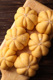 Photo of Raw pumpkin shaped buns on wooden table, top view