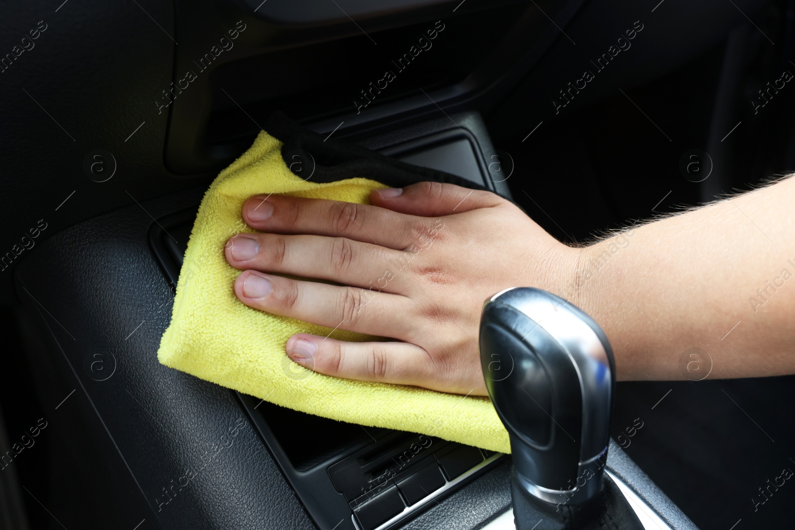 Photo of Man cleaning car interior with rag, closeup