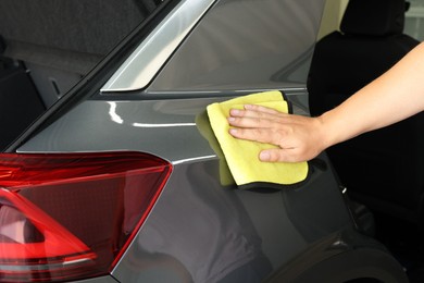 Man wiping auto with rag at car wash, closeup