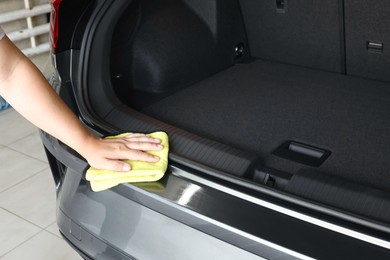 Man wiping auto with rag at car wash, closeup