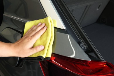 Photo of Man wiping auto with rag at car wash, closeup