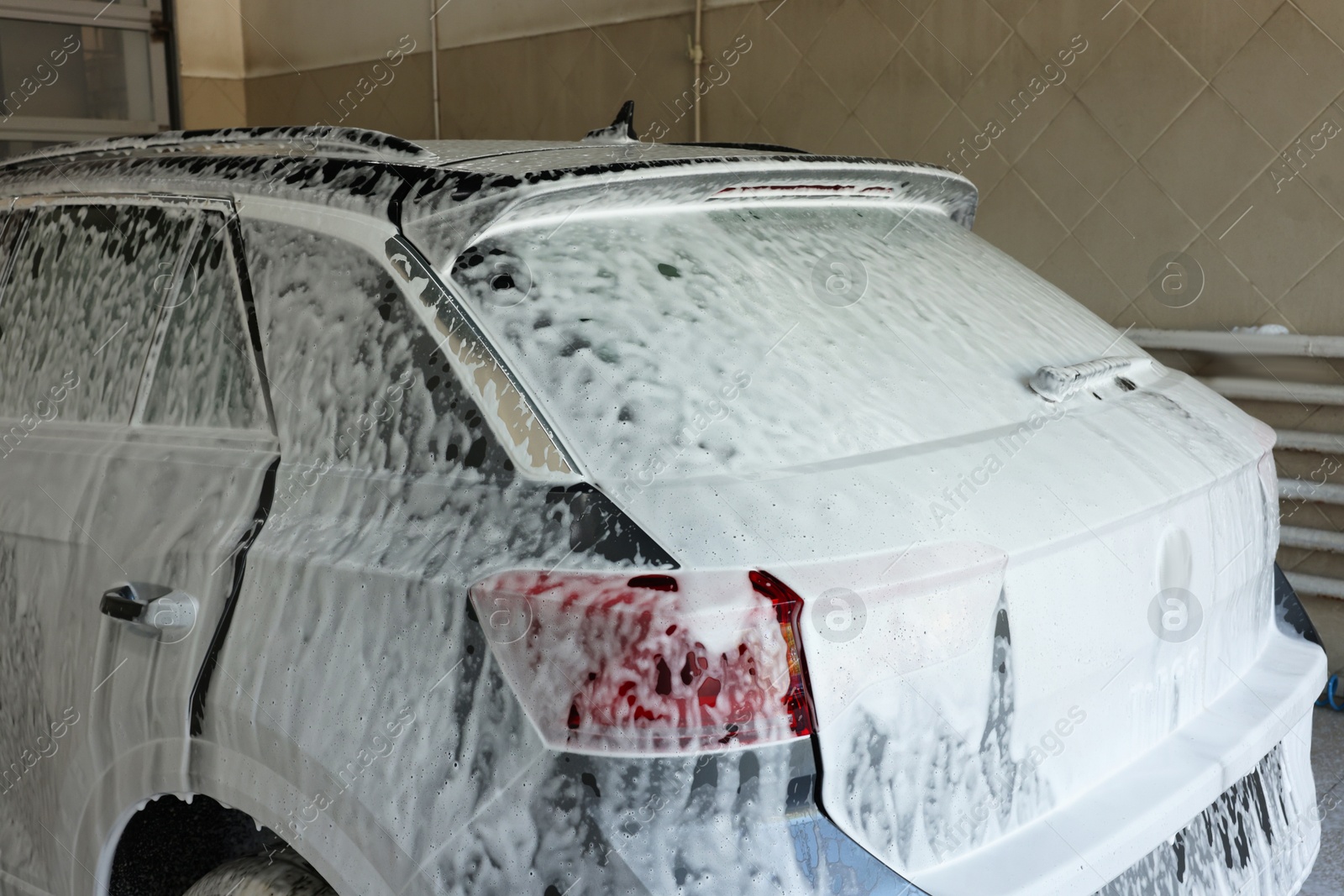 Photo of Auto covered with cleaning foam at car wash