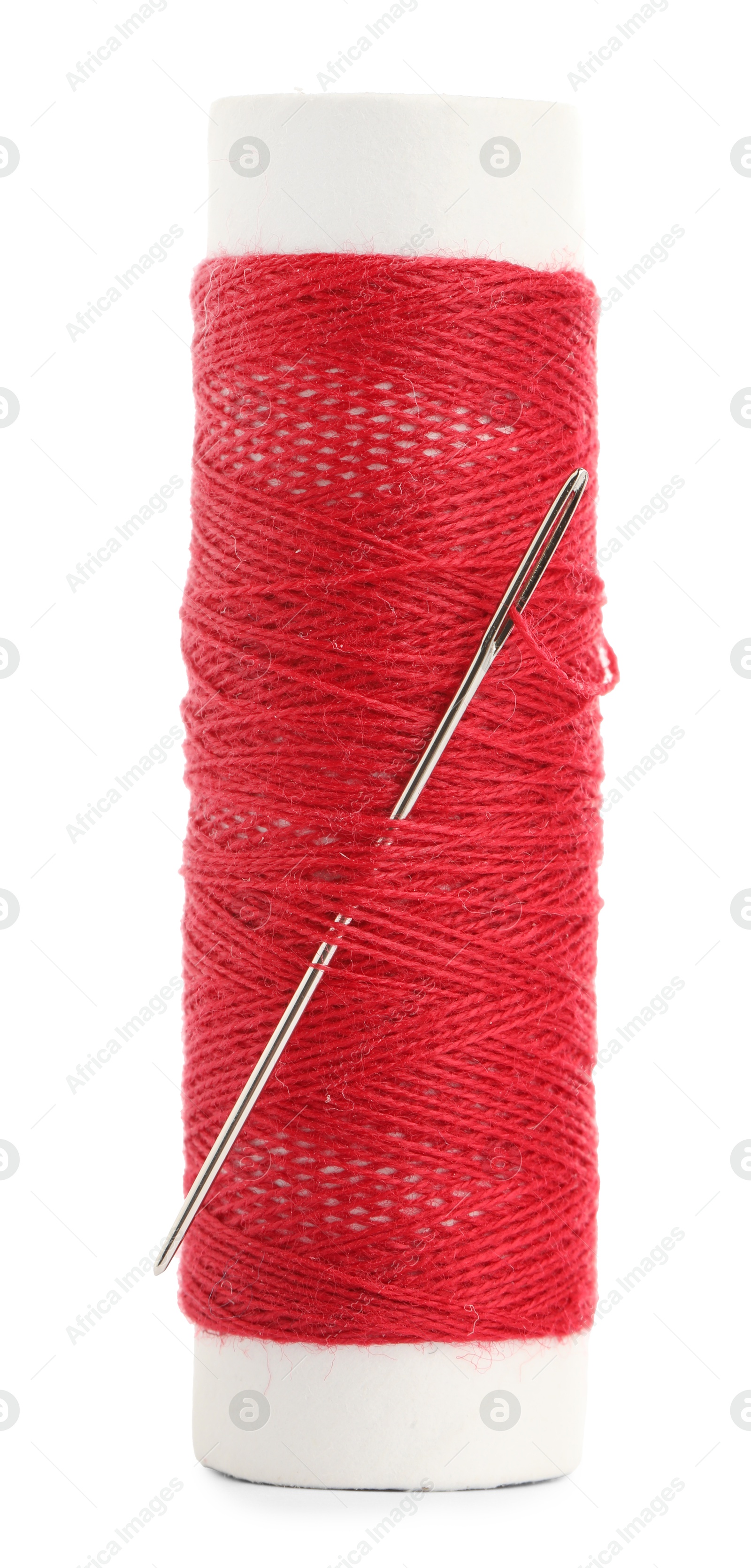 Photo of Spool of red sewing thread with needle isolated on white