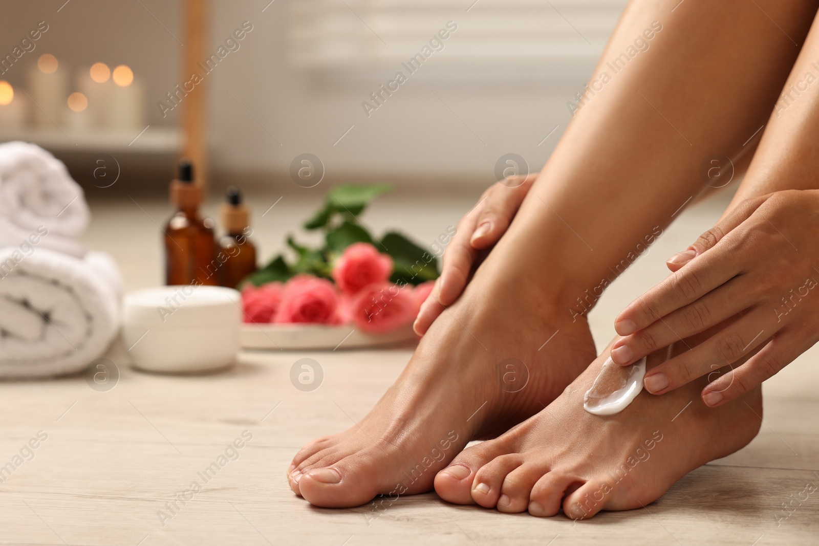 Photo of Woman touching her smooth feet on floor, closeup. Body care