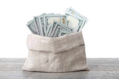 Photo of Dollar banknotes in bag on wooden table against white background