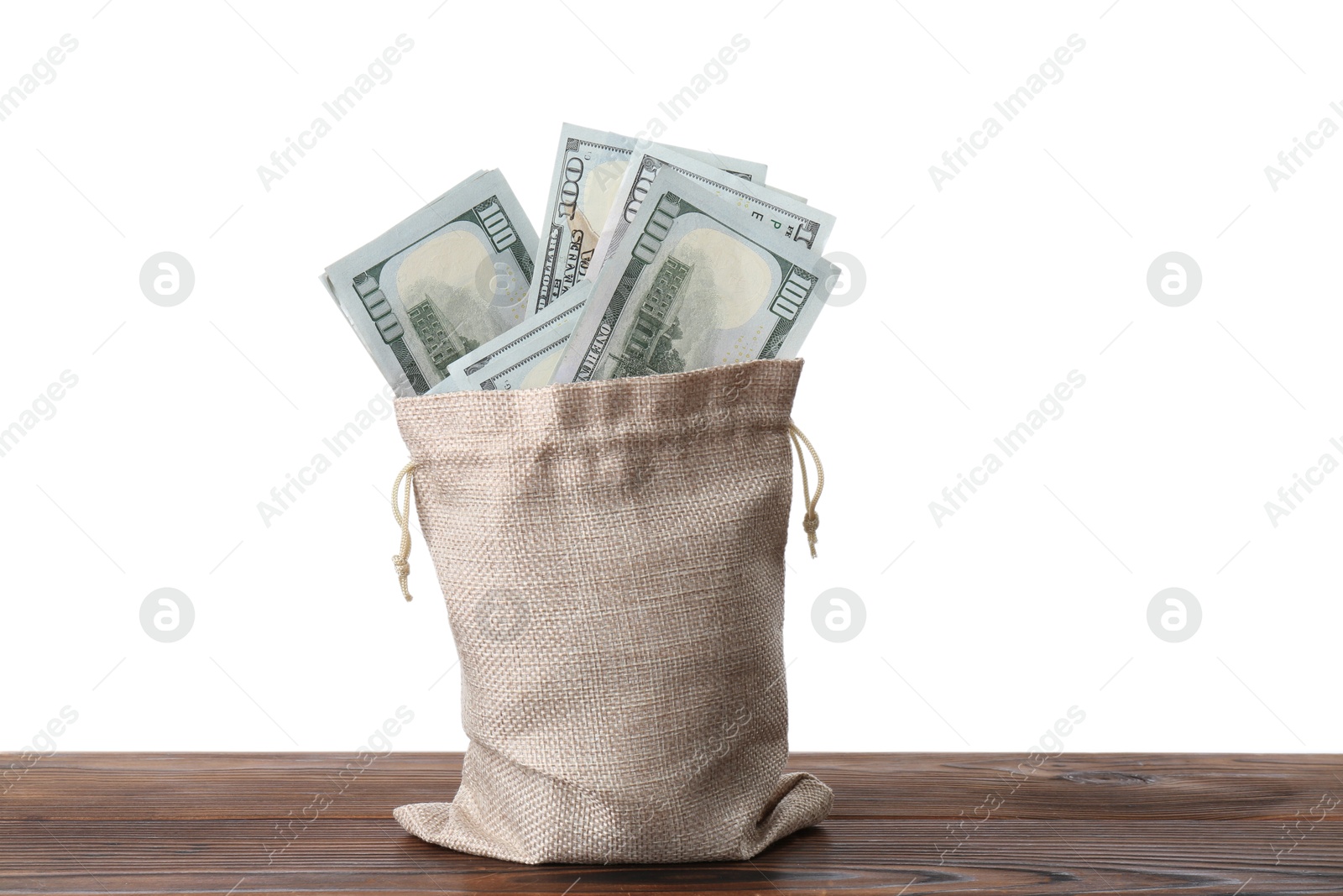 Photo of Dollar banknotes in bag on wooden table against white background