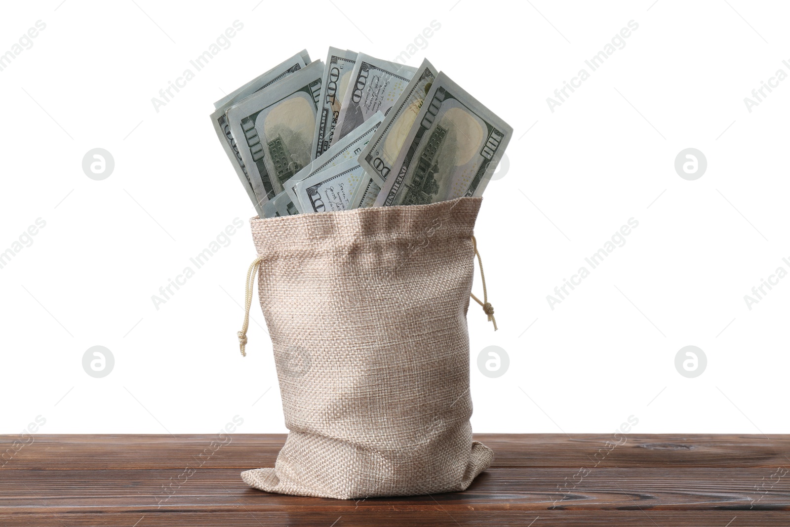 Photo of Dollar banknotes in bag on wooden table against white background