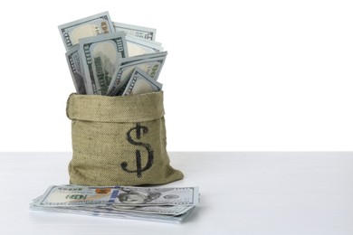 Dollar banknotes in bag on table against white background, space for text