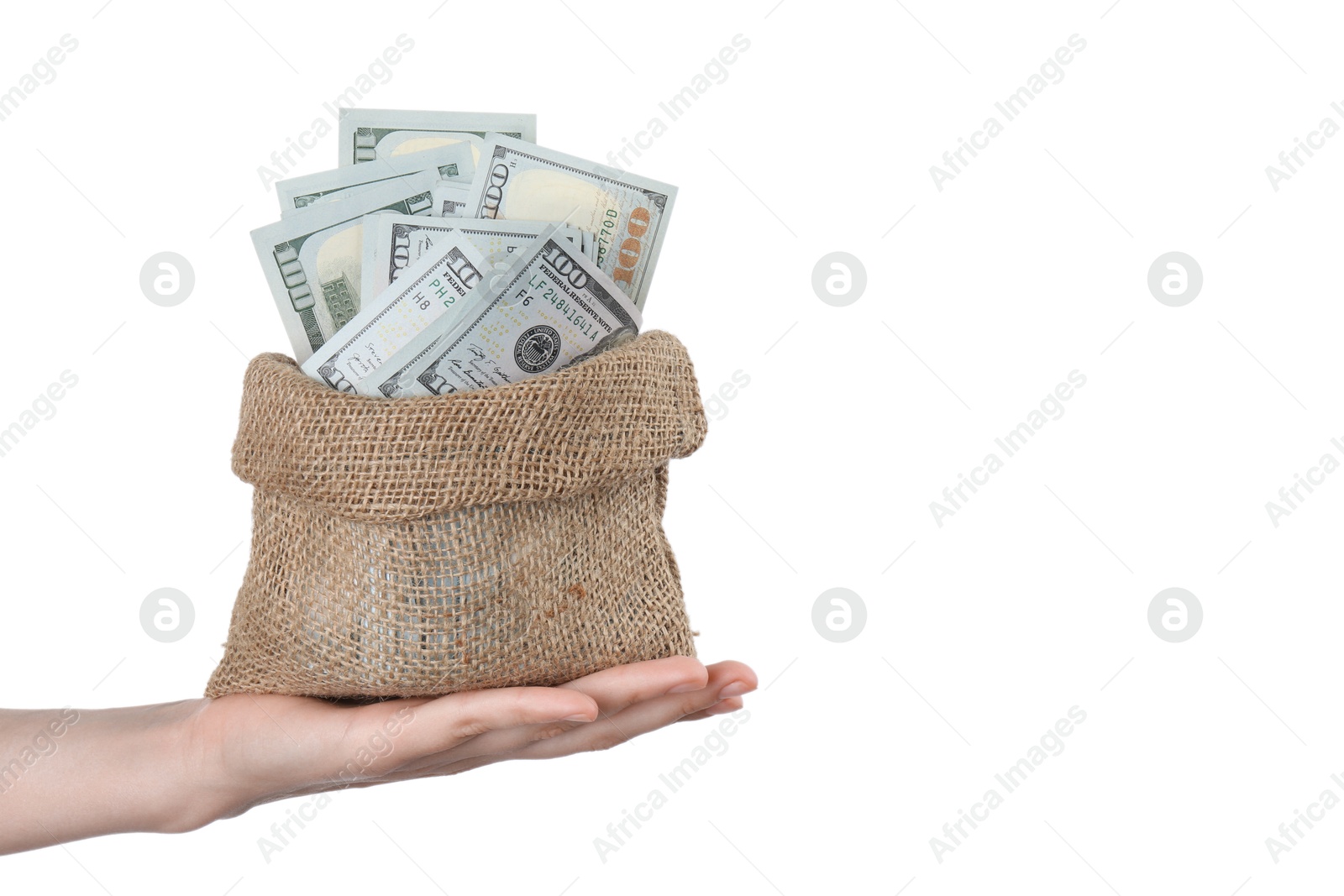 Photo of Woman with bag of dollar banknotes against light background, closeup