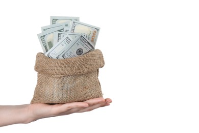 Photo of Woman with bag of dollar banknotes against light background, closeup