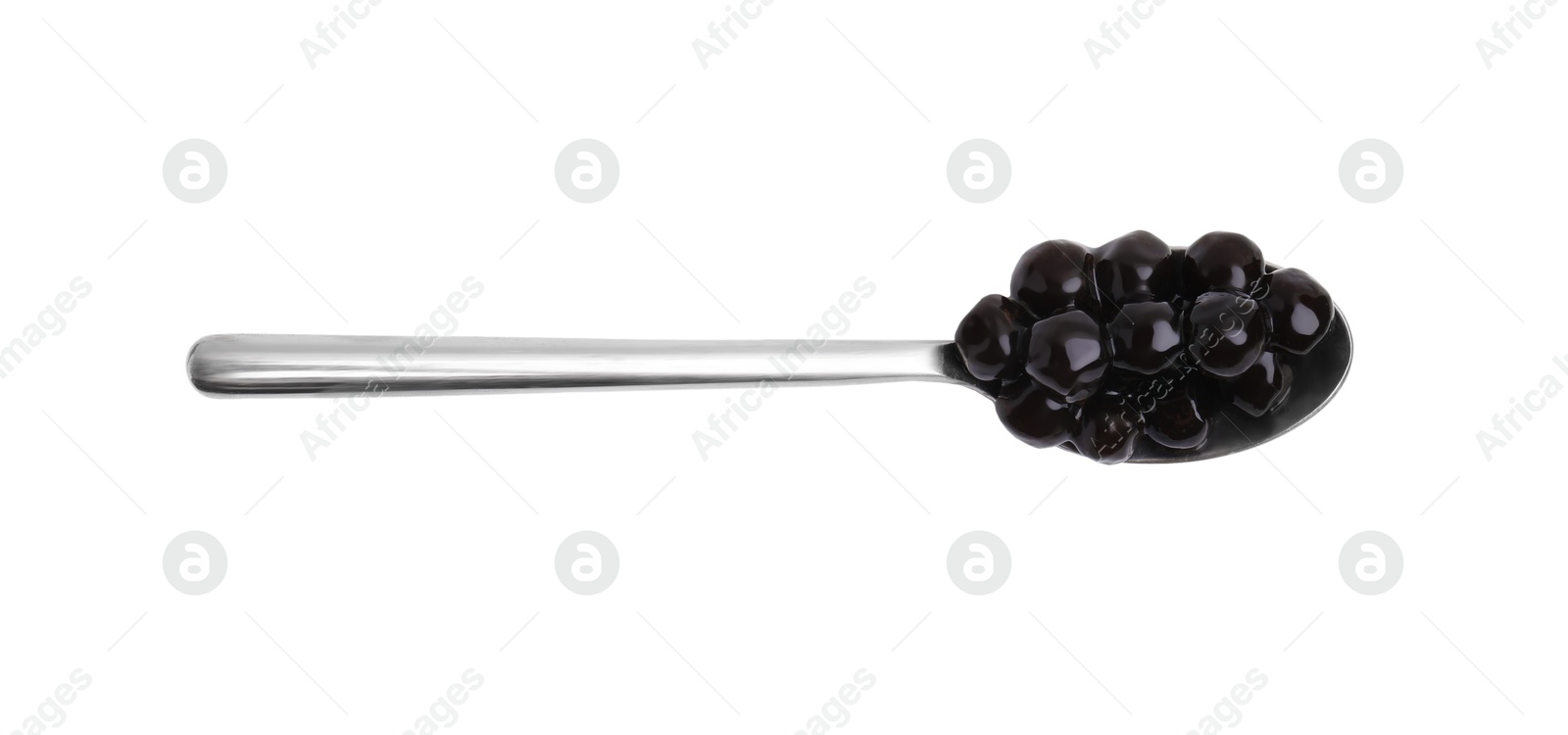 Photo of Dark tapioca pearls in spoon isolated on white, top view