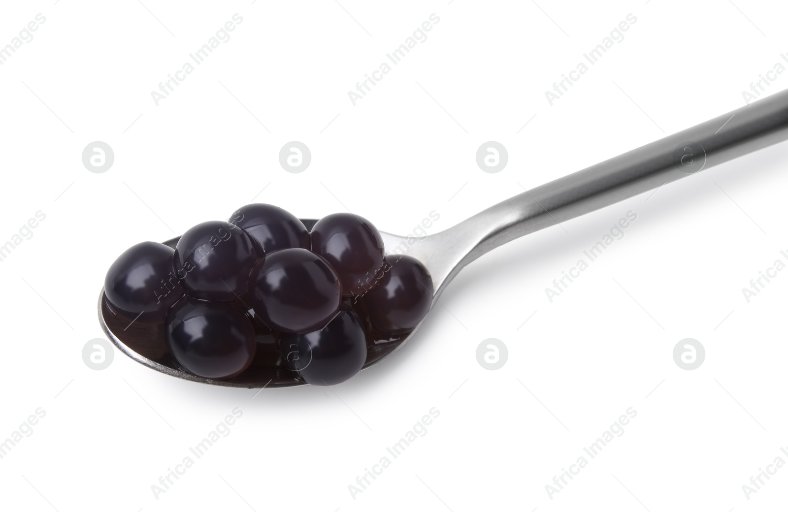 Photo of Dark tapioca pearls in spoon isolated on white