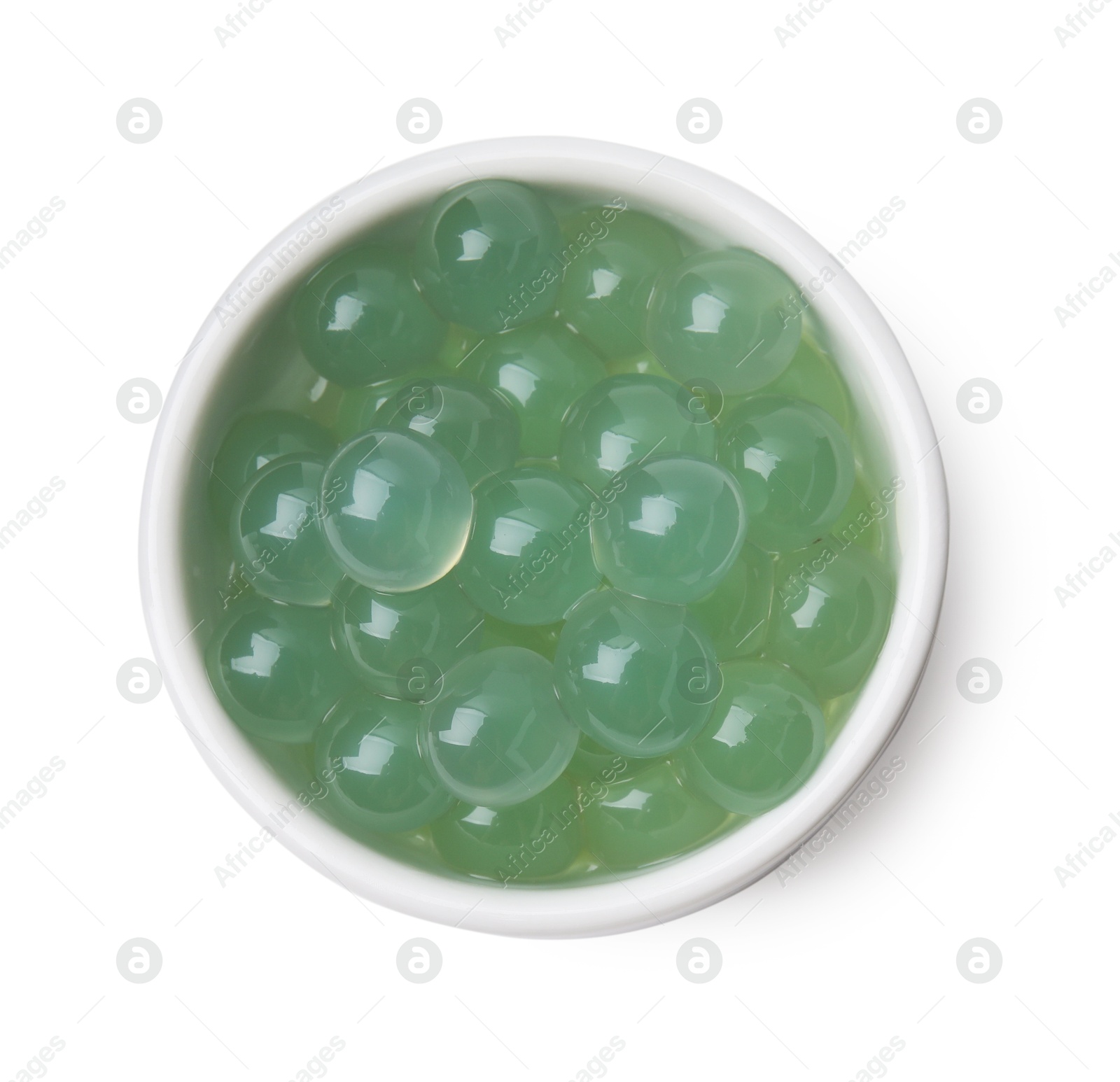 Photo of Bright tapioca pearls in bowl isolated on white, top view