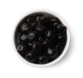 Photo of Dark tapioca pearls in bowl isolated on white, top view