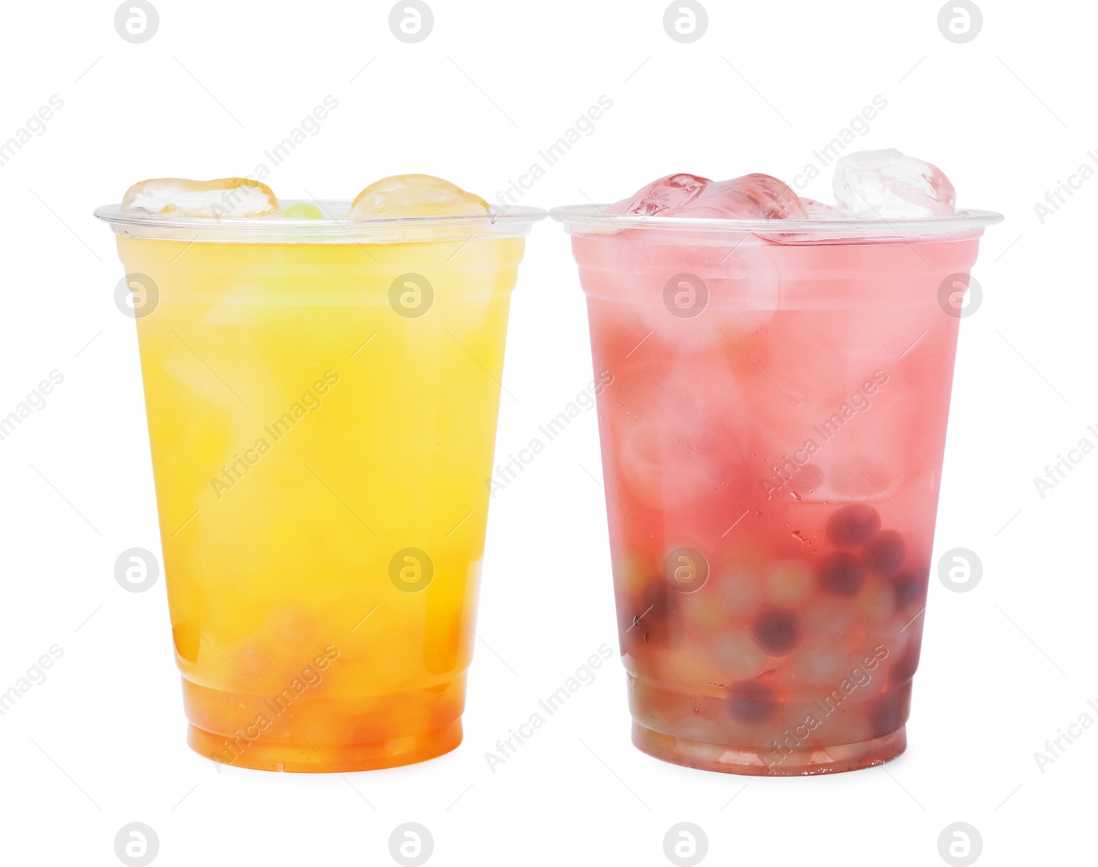 Photo of Tasty bubble tea in plastic cups isolated on white