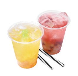 Photo of Tasty bubble tea in plastic cups and straws isolated on white