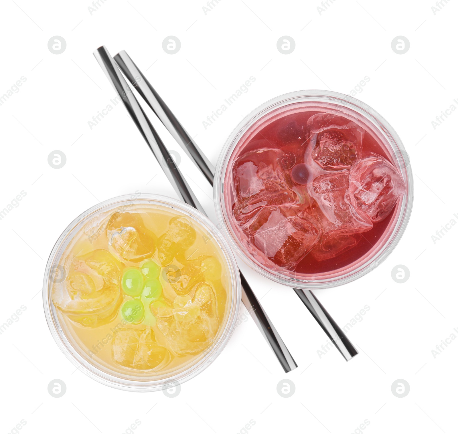 Photo of Tasty bubble tea in plastic cups and straws isolated on white, top view