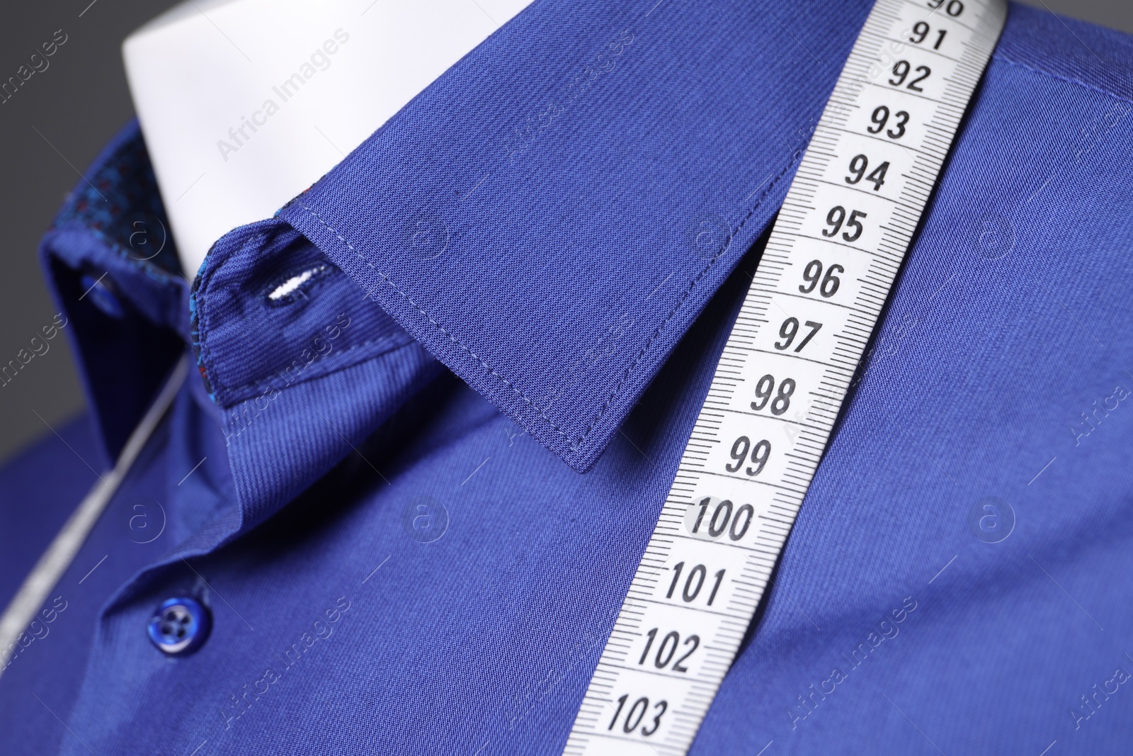 Photo of Mannequin with blue shirt and measuring tape, closeup