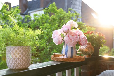 Photo of Balcony garden. Different plants growing on railings outdoors