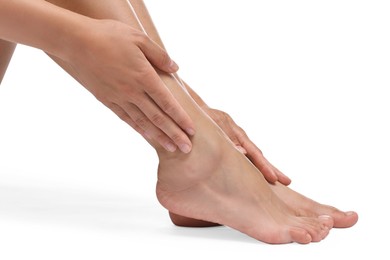 Photo of Woman touching her smooth feet on white background, closeup