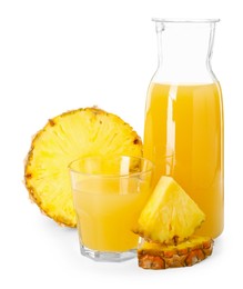 Photo of Glass with tasty pineapple juice, jug and pieces of fresh fruit isolated on white