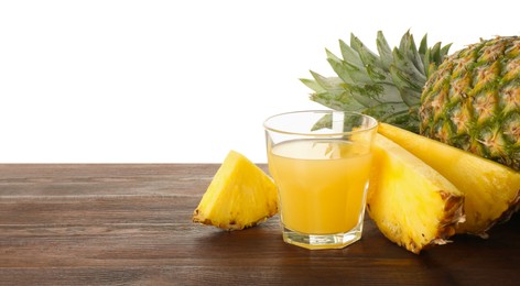 Photo of Glass with pineapple juice and fresh pineapples on wooden table against white background