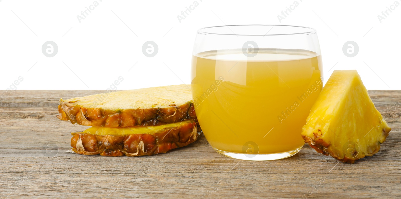 Photo of Tasty pineapple juice in glass and slices of fresh fruit on wooden table against white background. Space for text